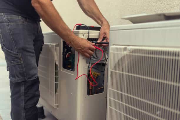 Technician installing heat pump