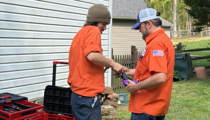 Two Technicins Working Outside